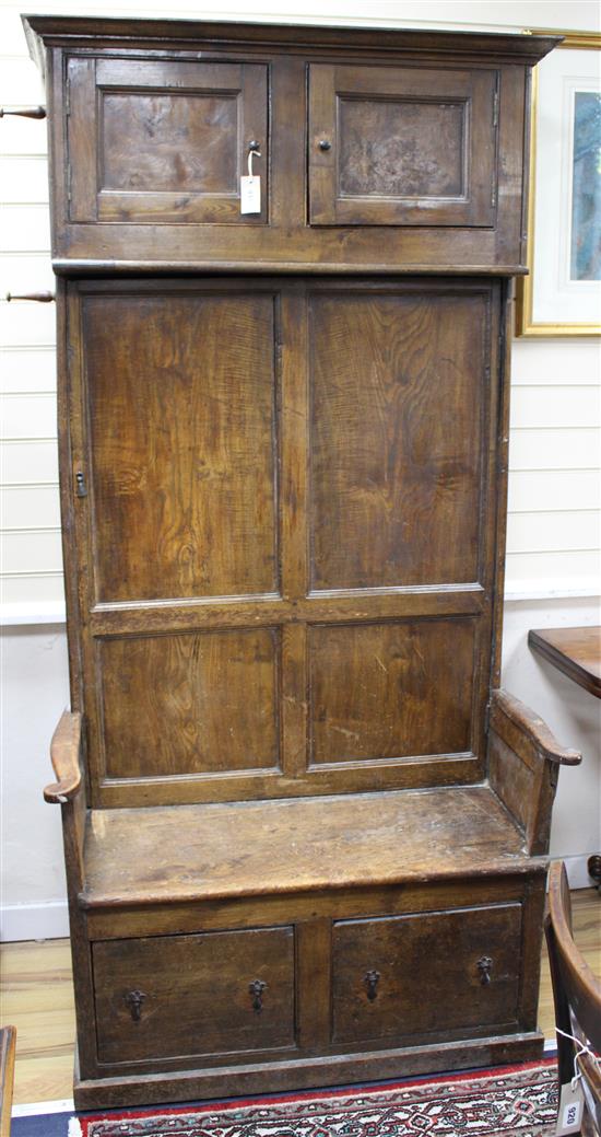 An 18th/19th century elm box seat settle with cupboard over H.205cm